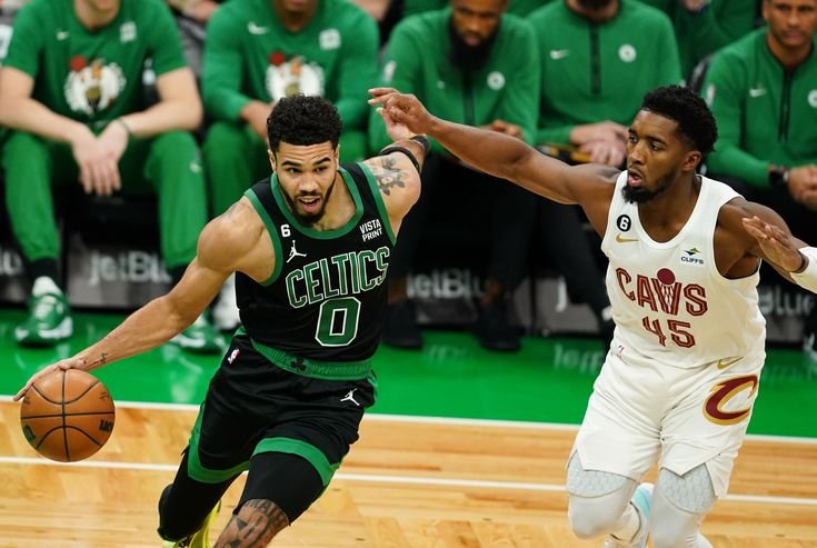 Cleveland Cavaliers and Boston Celtics players during a heated moment on the court."